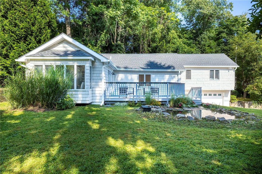 31 S Road Katonah, NY 10536 - Photo 1 of 1 View of front of home with a wooden deck, a pond, and a front yard