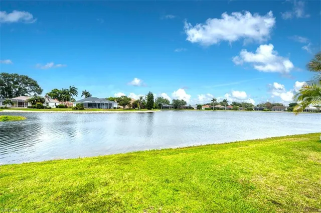 a view of a lake with houses in the background