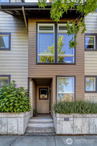 a front view of a house with plants