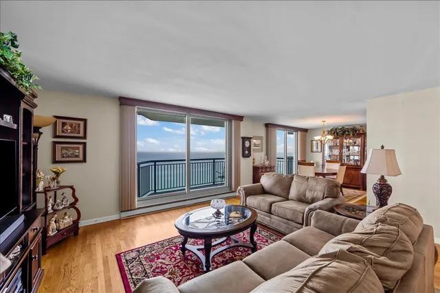 a living room with furniture a flat screen tv and a window