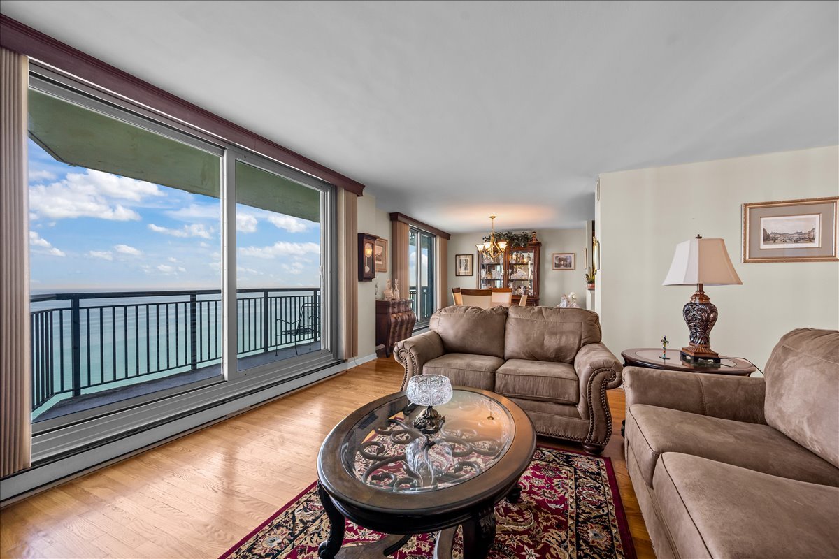 6007 North Sheridan Road, Unit 37B Chicago, IL 60660 - Photo 8 of 31 a living room with furniture a table and a large window