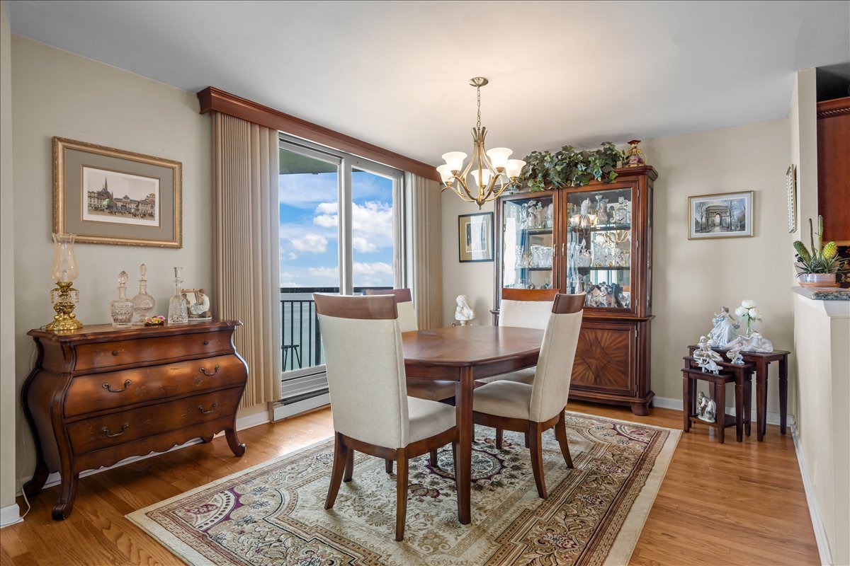 6007 North Sheridan Road, Unit 37B Chicago, IL 60660 - Photo 9 of 31 a living room with furniture and a chandelier