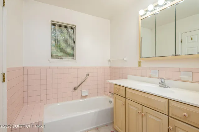 a bedroom with a flat screen tv and a bed