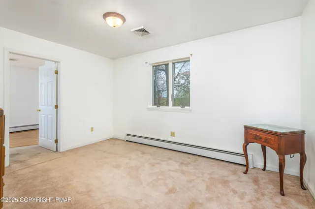 a view of an empty room and closet area