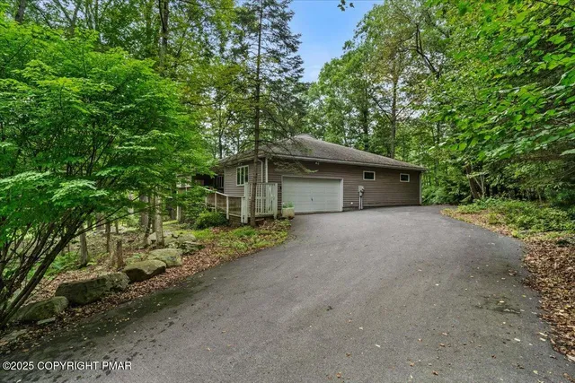 an aerial view of residential houses with outdoor and green space
