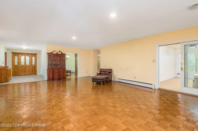 a dining room with furniture and a chandelier
