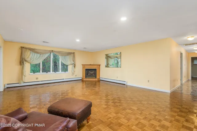 a view of a dining room with furniture and chandelier
