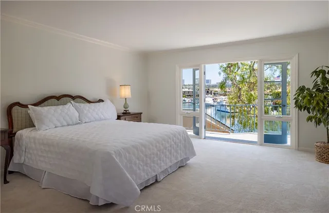 a spacious bedroom with a bed and a large window