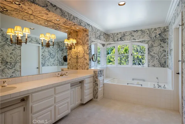a bathroom with a tub a sink and mirror