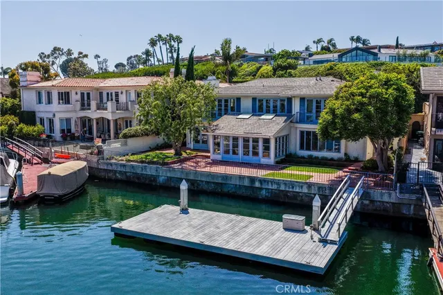 a view of a house with pool and chairs