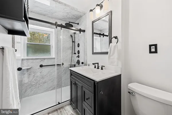 a bathroom with a sink toilet and shower