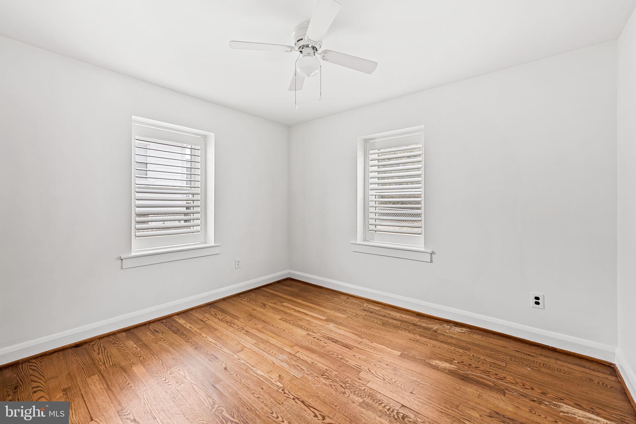 440 Cleveland Road Linthicum Heights, MD 21090 - Photo 12 of 28 a view of an empty room with wooden floor and a window