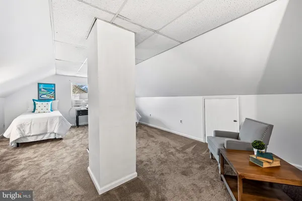 a bedroom with furniture and a window