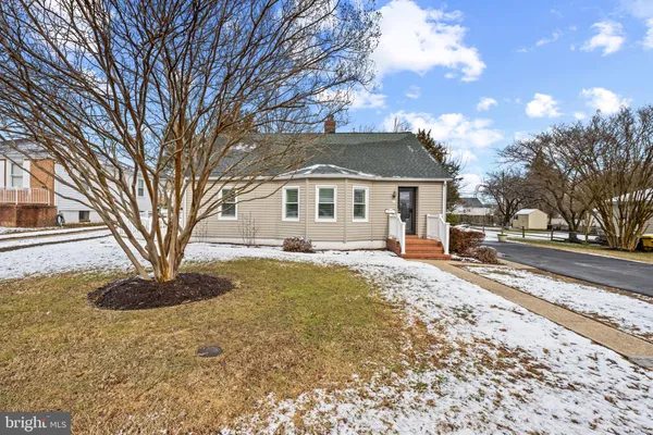 a front view of a house with a yard covered in snow