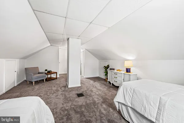 a bed room with a bed and a chair