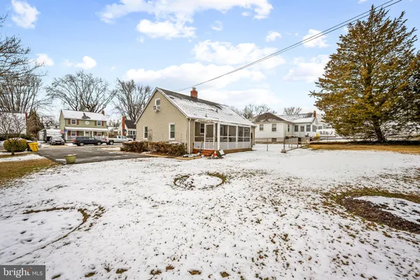a view of residential houses with snow on the road