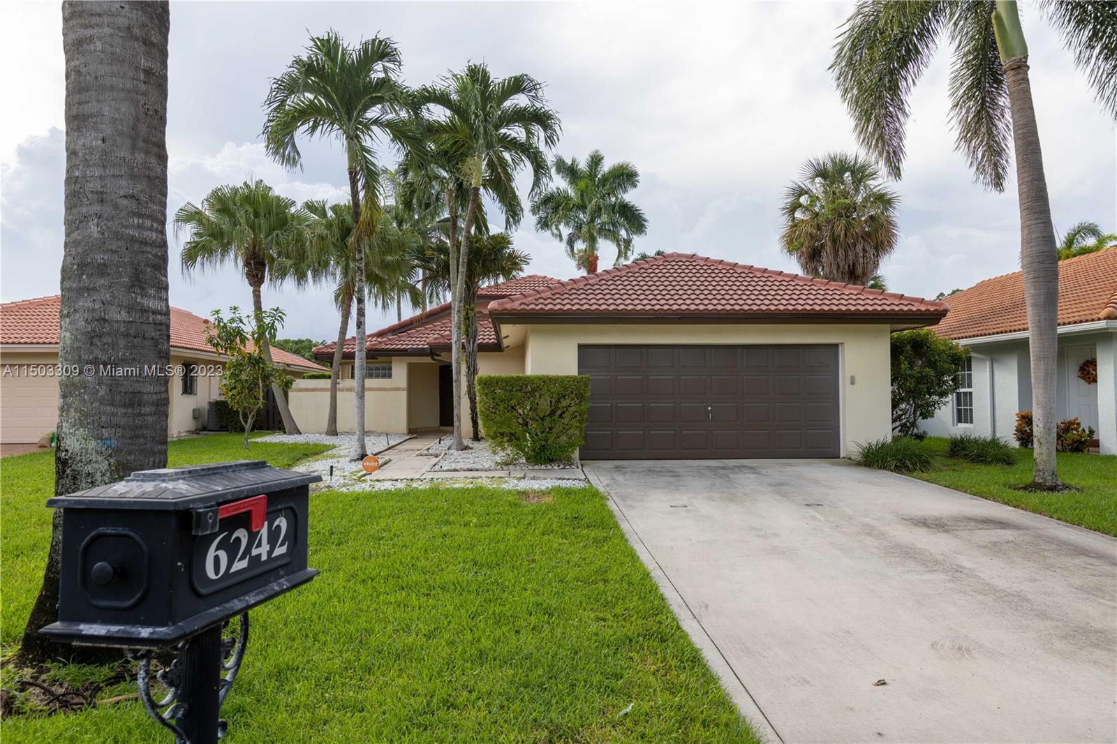 6242 Sweet Maple Lane Boca Raton, FL 33433 - Photo 1 of 31 a front view of a house with garden