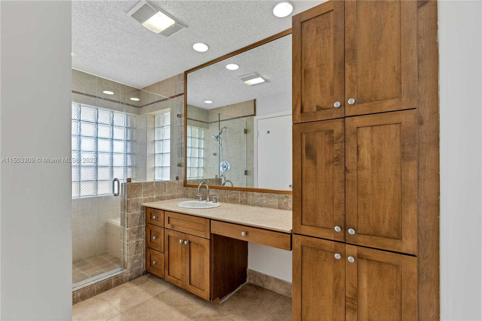 6242 Sweet Maple Lane Boca Raton, FL 33433 - Photo 16 of 31 a bathroom with a sink a mirror and a shower