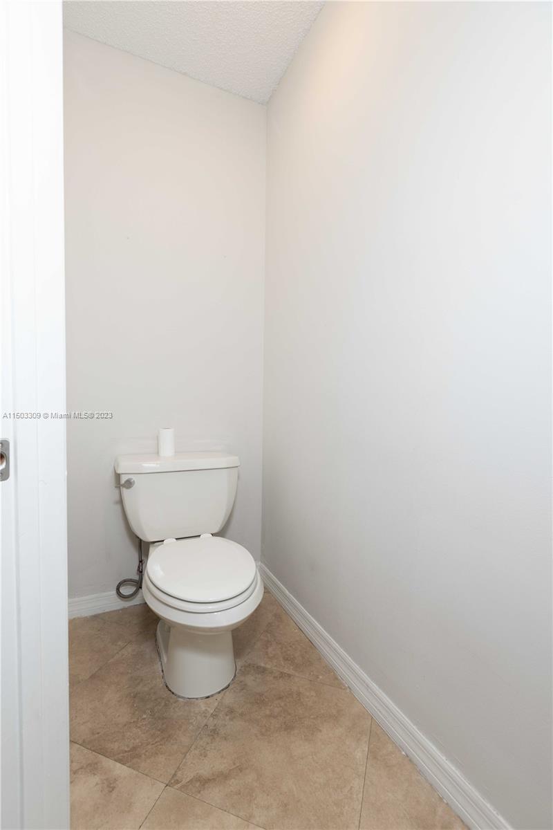 6242 Sweet Maple Lane Boca Raton, FL 33433 - Photo 20 of 31 a white toilet sitting next to a white wall