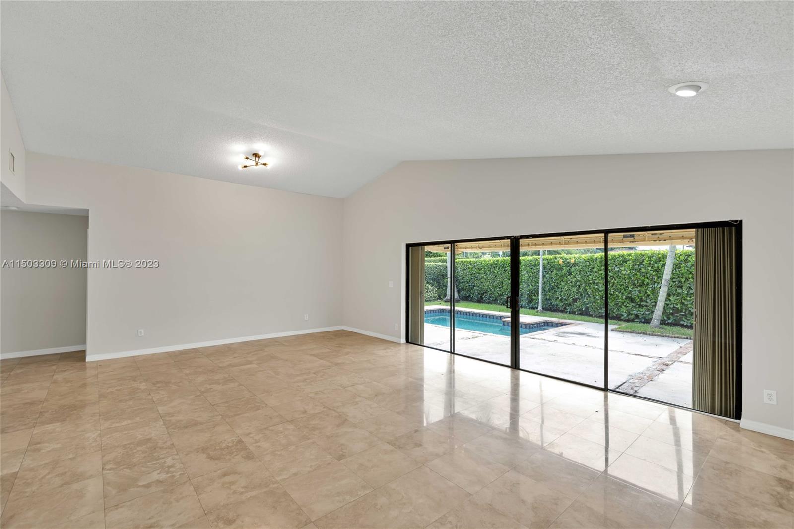 6242 Sweet Maple Lane Boca Raton, FL 33433 - Photo 2 of 31 a view of an empty room with a sliding door