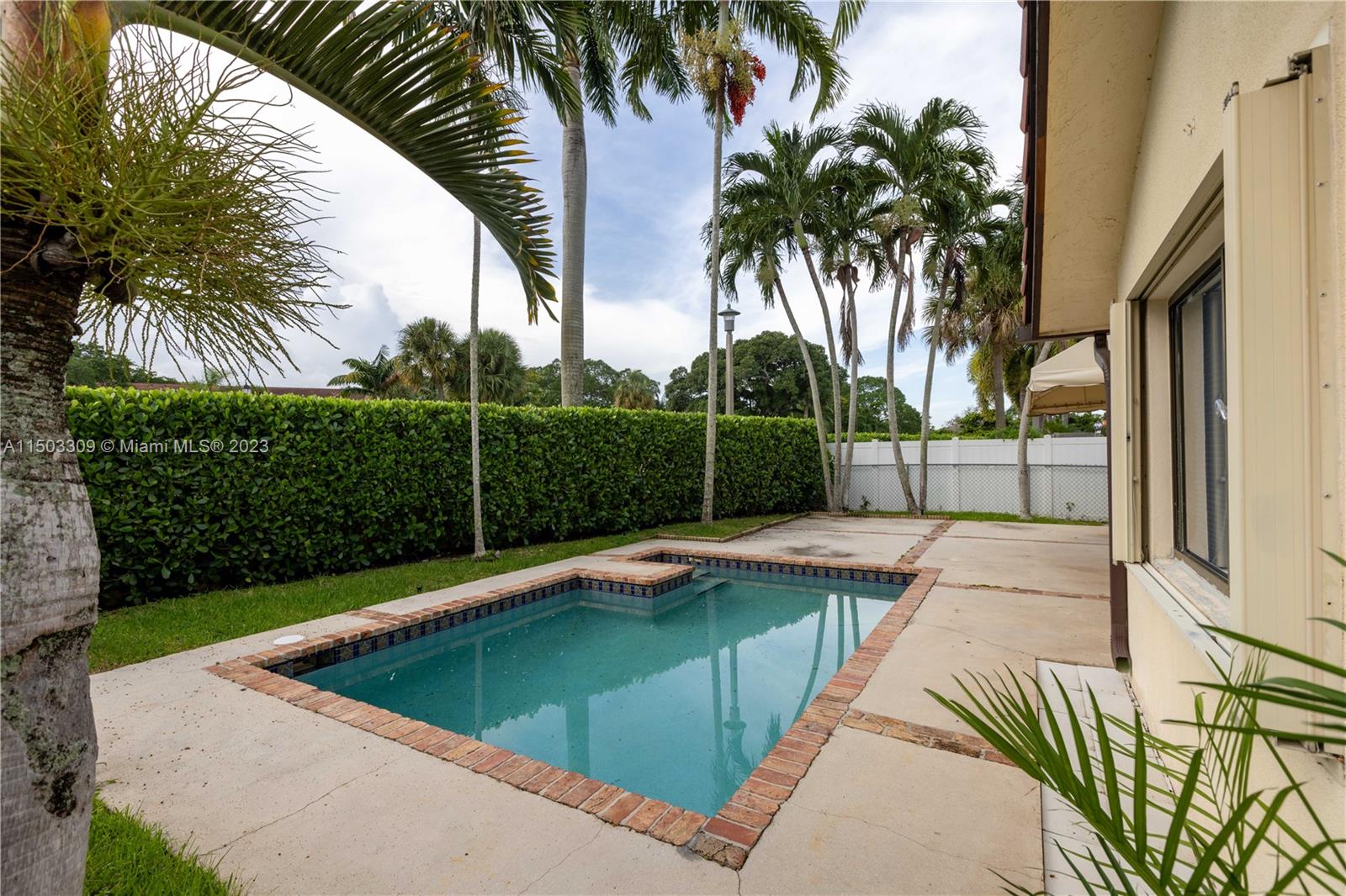 6242 Sweet Maple Lane Boca Raton, FL 33433 - Photo 25 of 31 a view of swimming pool with a garden and trees