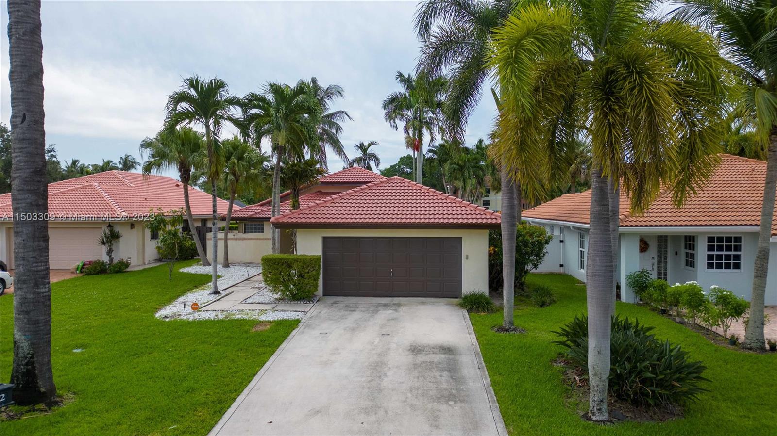 6242 Sweet Maple Lane Boca Raton, FL 33433 - Photo 29 of 31 a front view of a house with a garden and trees