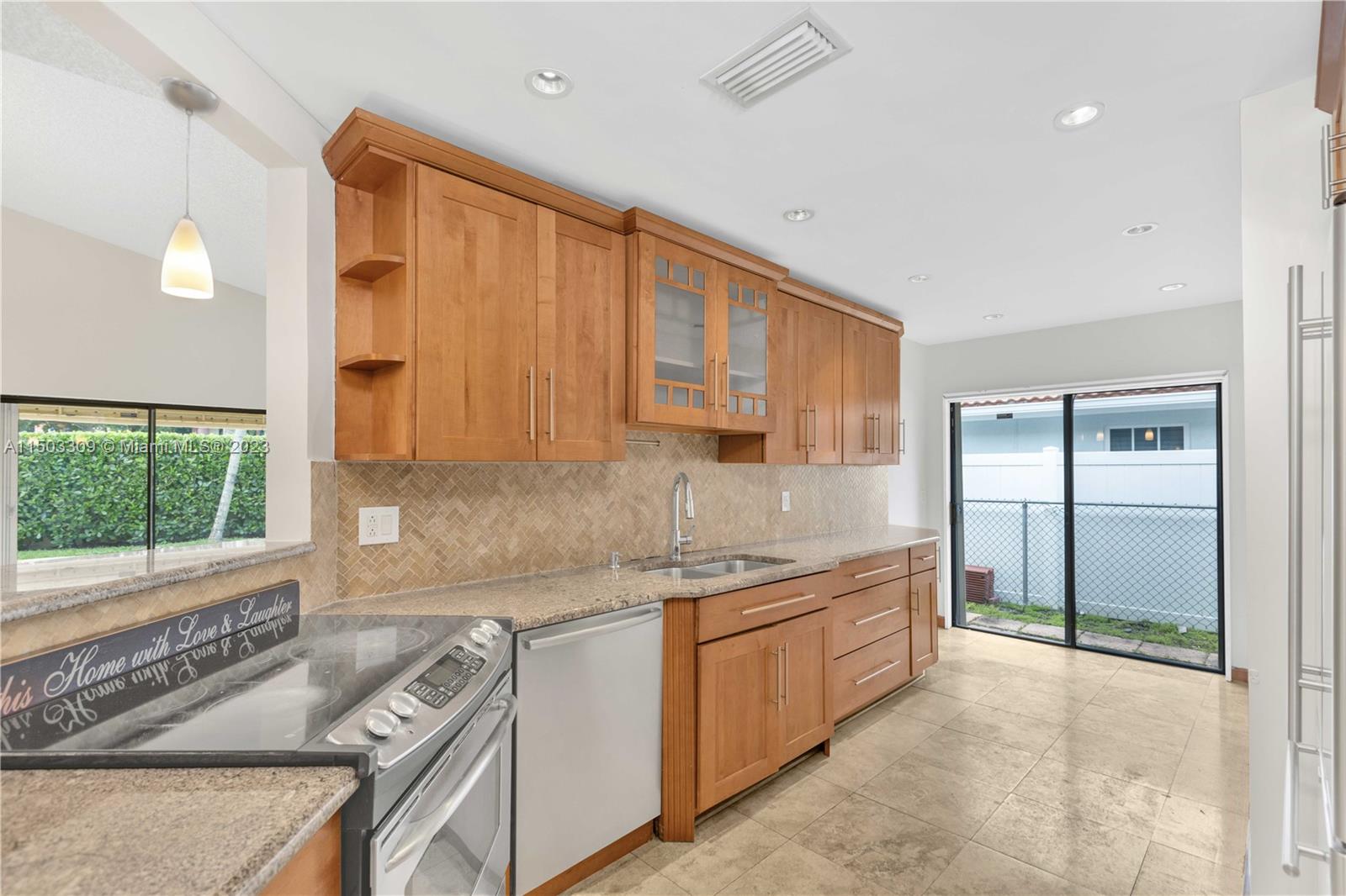 6242 Sweet Maple Lane Boca Raton, FL 33433 - Photo 6 of 31 a kitchen that has a sink and a stove in it