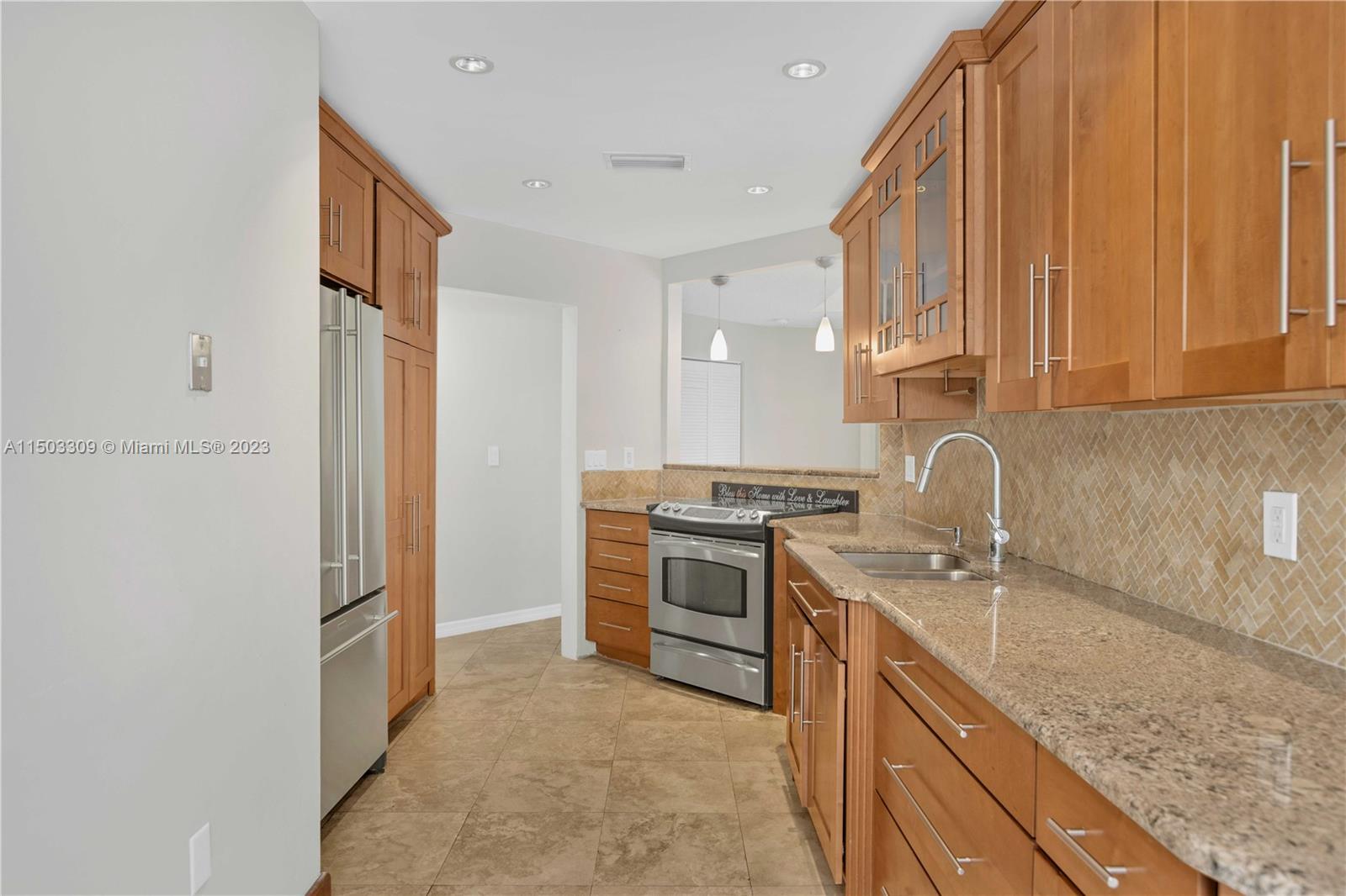 6242 Sweet Maple Lane Boca Raton, FL 33433 - Photo 7 of 31 a kitchen with a sink stove and refrigerator