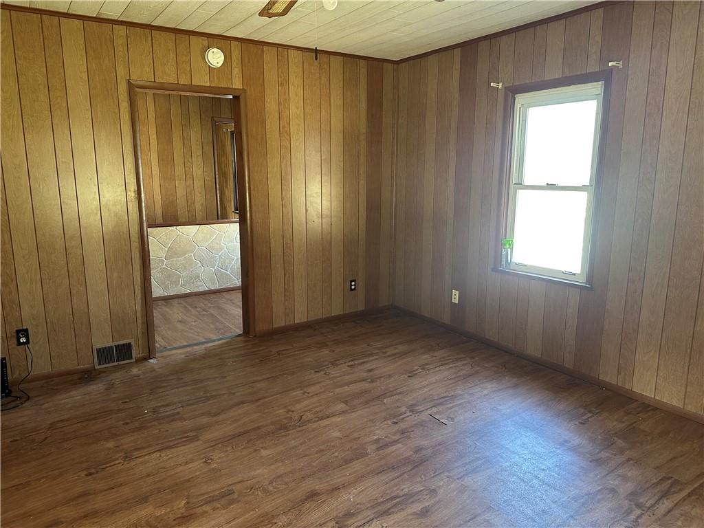 1423 Maratta Road Aliquippa, PA 15001 - Photo 13 of 22 an empty room with wooden floor and windows with curtains