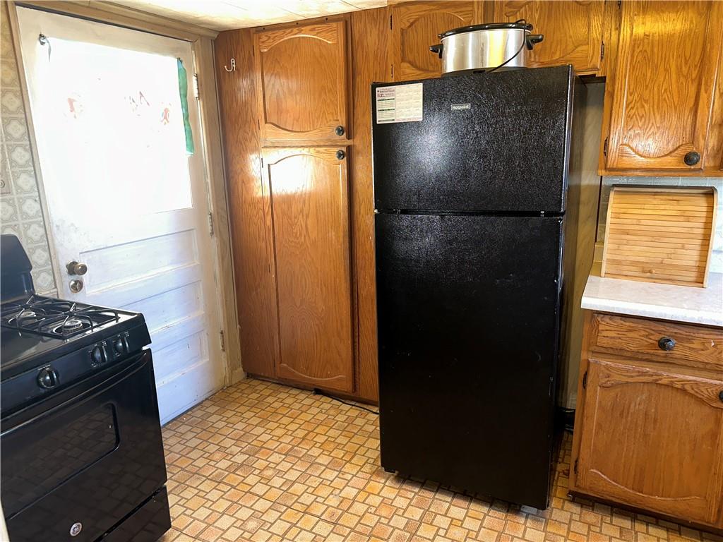 1423 Maratta Road Aliquippa, PA 15001 - Photo 3 of 22 a kitchen with a refrigerator and a stove