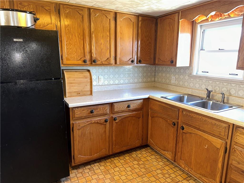 1423 Maratta Road Aliquippa, PA 15001 - Photo 5 of 22 a kitchen with stainless steel appliances granite countertop a sink a stove and a microwave