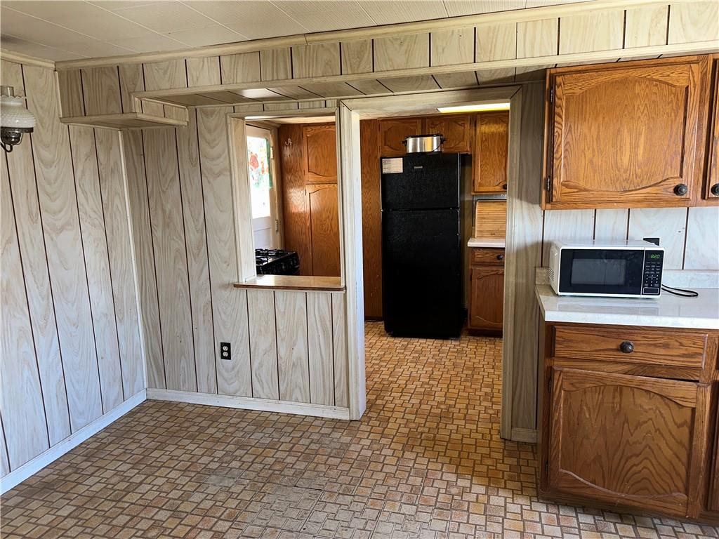 1423 Maratta Road Aliquippa, PA 15001 - Photo 6 of 22 a view of a refrigerator in kitchen and wooden cabinets
