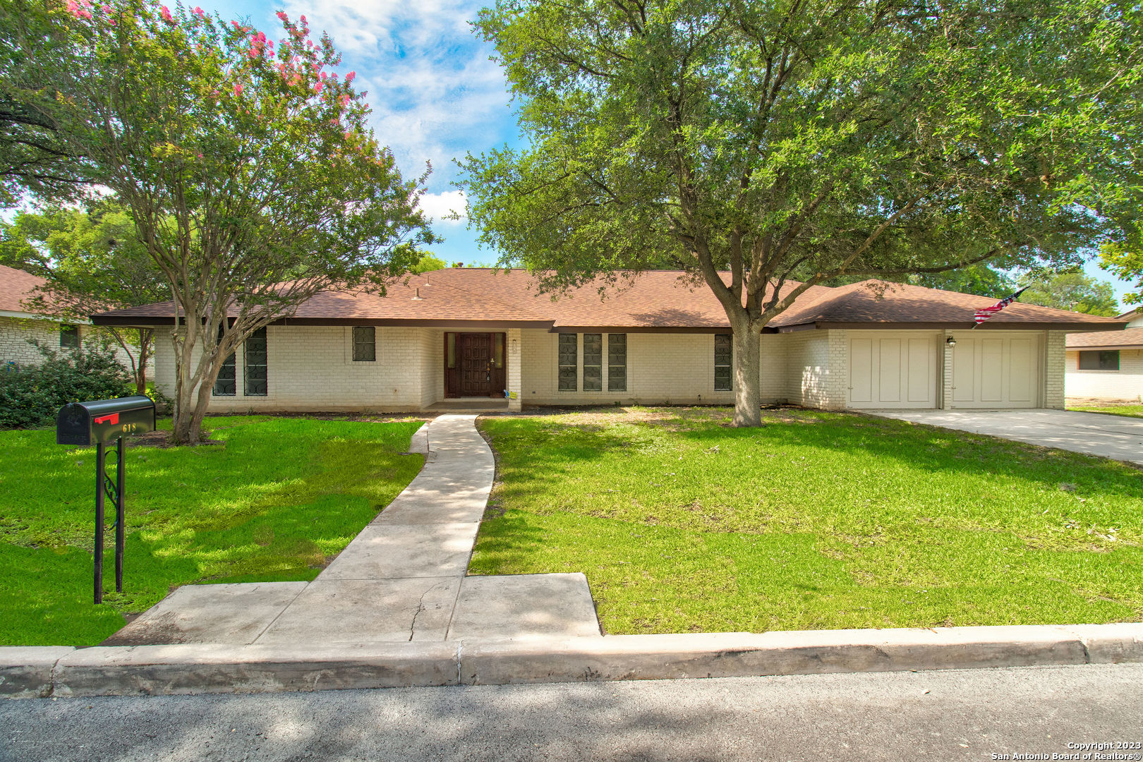 a front view of a house with a garden