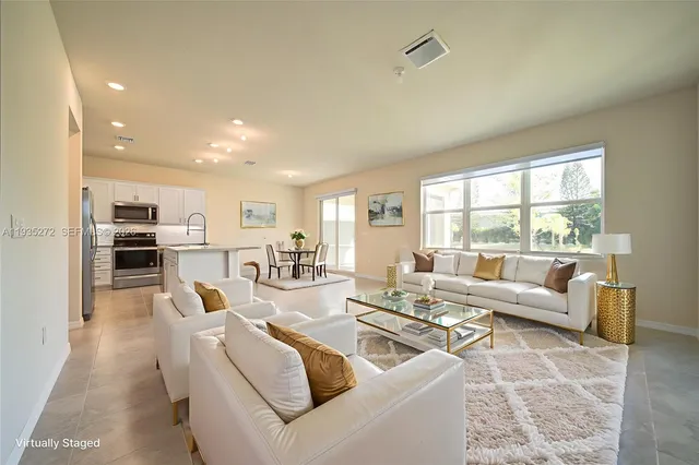 a living room with furniture and a large window