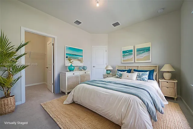 a bedroom with a bed and a potted plant