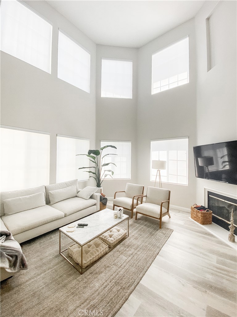 a living room with furniture wooden floor and a flat screen tv