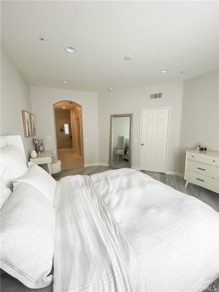 151 Islington Irvine, CA 92620 - Photo 12 of 15 a bedroom with a bed and a mirror