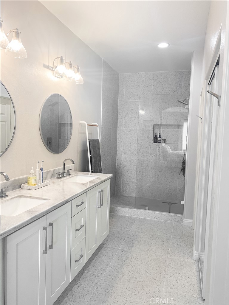 151 Islington Irvine, CA 92620 - Photo 13 of 15 a bathroom with a double vanity sink mirror and shower