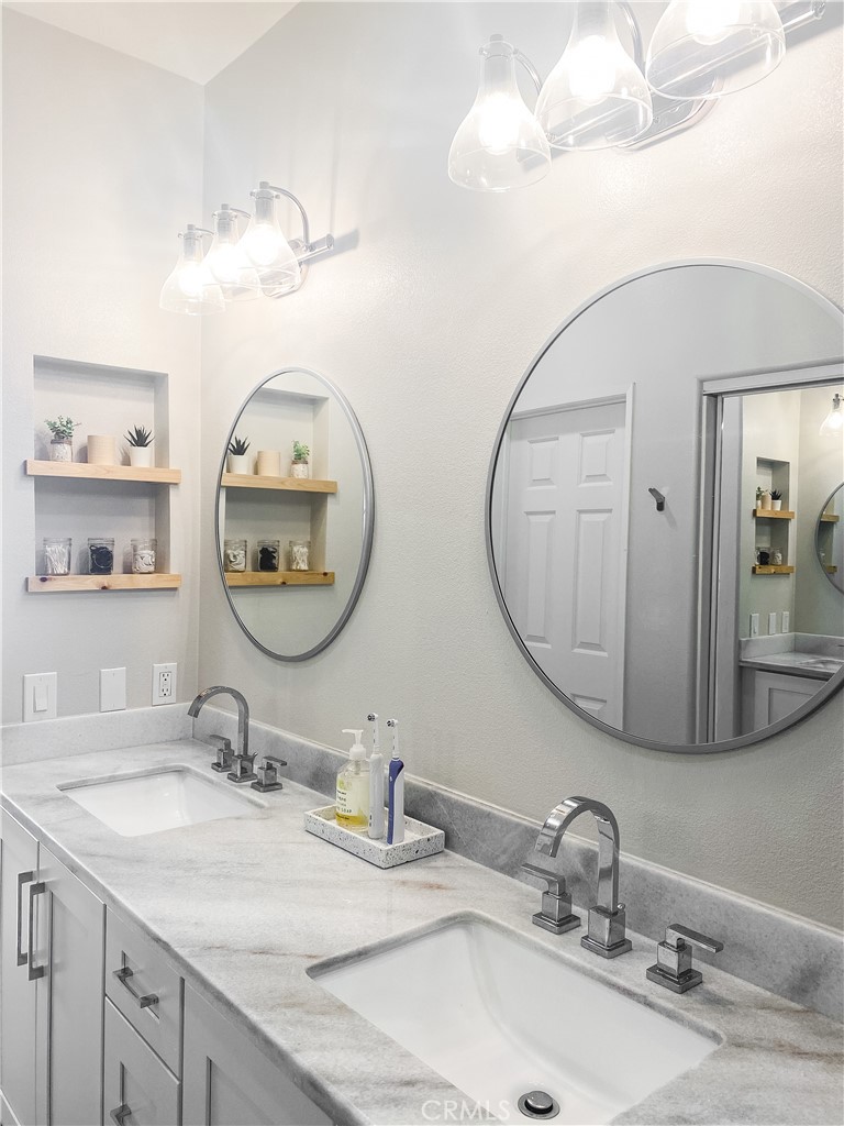 151 Islington Irvine, CA 92620 - Photo 14 of 15 a bathroom with double vanity sinks and a mirror