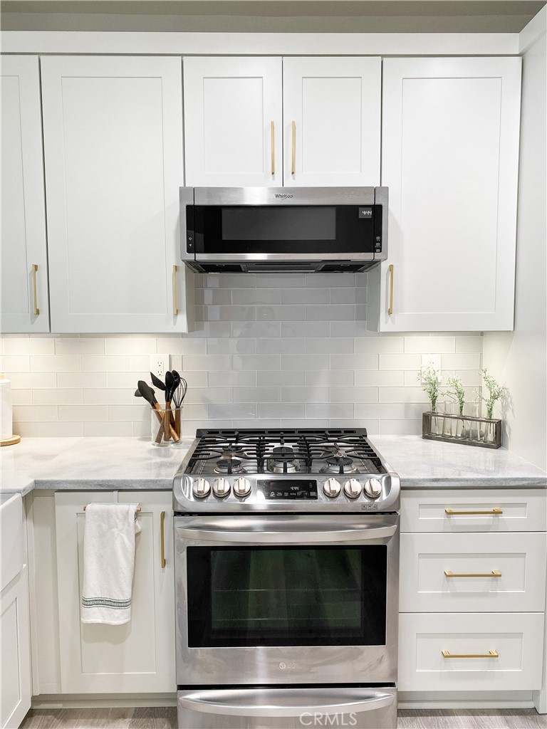 151 Islington Irvine, CA 92620 - Photo 4 of 15 a stove top oven sitting inside of a kitchen