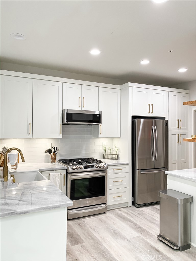 151 Islington Irvine, CA 92620 - Photo 5 of 15 a kitchen with a sink stainless steel appliances and cabinets