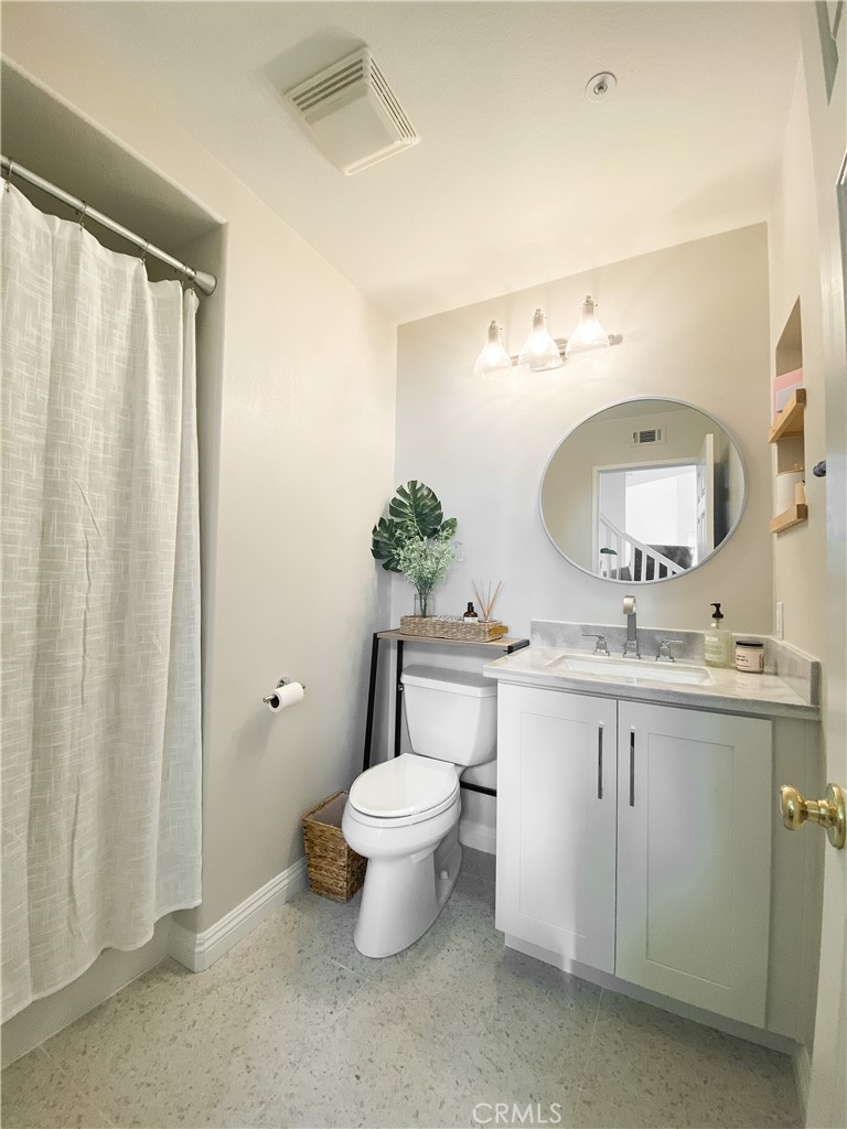 151 Islington Irvine, CA 92620 - Photo 10 of 15 a bathroom with a toilet a sink and a mirror