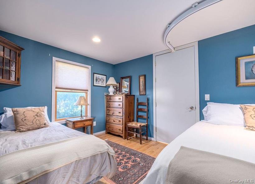 1020 Ruch Lane Southold, NY 11971 - Photo 14 of 35 a bedroom with a bed and a large window