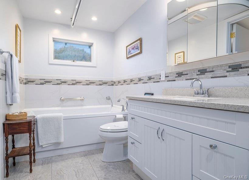 1020 Ruch Lane Southold, NY 11971 - Photo 15 of 35 a bathroom with a toilet sink and mirror