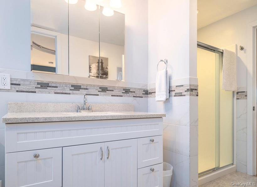 1020 Ruch Lane Southold, NY 11971 - Photo 16 of 35 a bathroom with a sink and a mirror