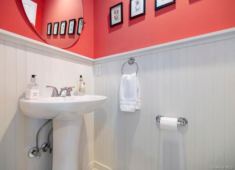 1020 Ruch Lane Southold, NY 11971 - Photo 8 of 35 a bathroom with a sink a mirror and vanity