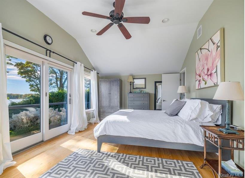 1020 Ruch Lane Southold, NY 11971 - Photo 10 of 35 a bedroom with a bed and a lamp next to a window