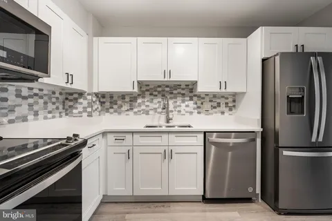 a kitchen with stainless steel appliances and cabinets