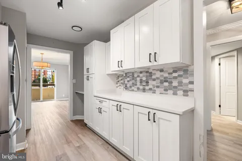 a kitchen with granite countertop a sink and a refrigerator