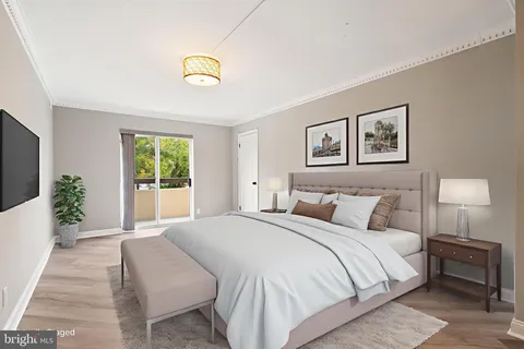 a spacious bedroom with a bed a couch and a window